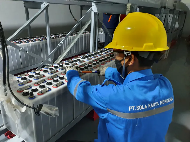 SKB technician servicing an industrial battery bank